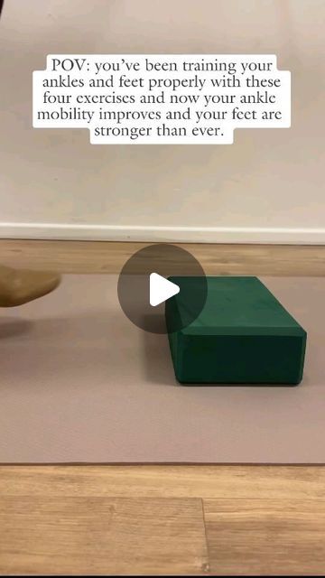 a green box sitting on top of a wooden floor next to a vase and bowl