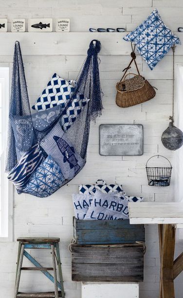 a room filled with lots of blue and white towels hanging on the wall next to a window