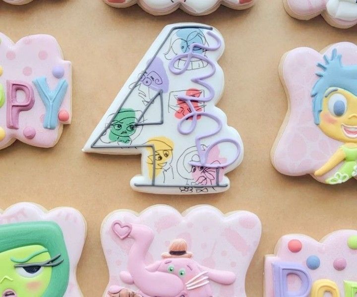 decorated cookies with the number four and cartoon characters on them are arranged in various shapes