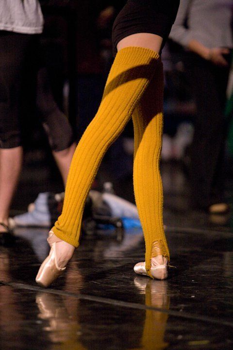 the legs and feet of dancers in yellow socks