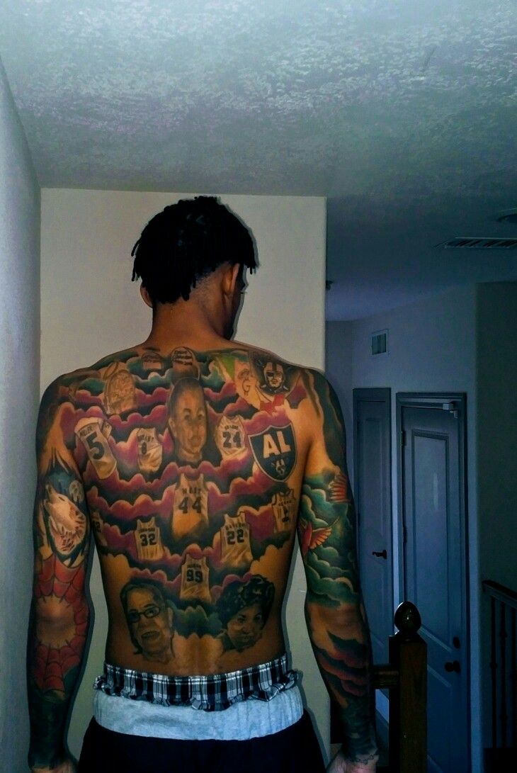 a man with many tattoos on his back