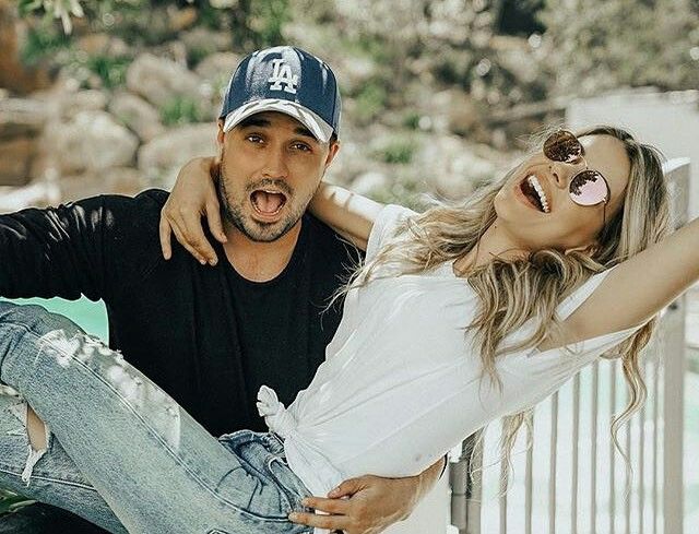 a man and woman posing for the camera