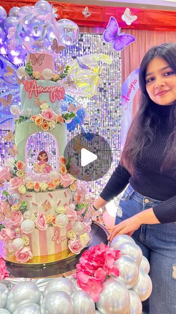 a woman standing in front of a cake