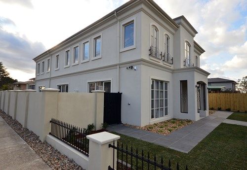 a large white house sitting on the side of a road