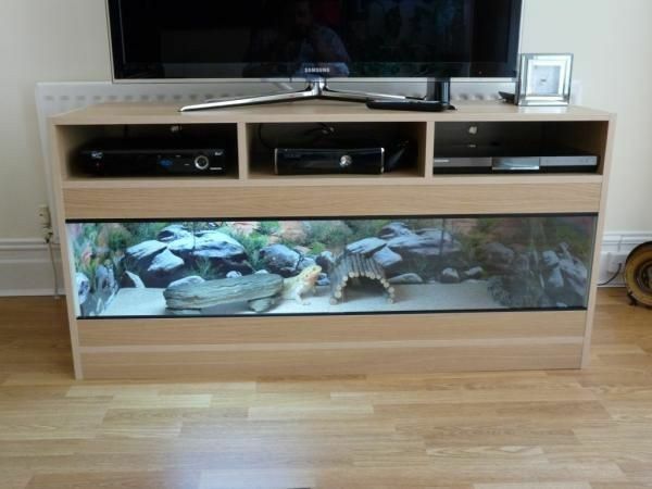 an entertainment center with a fish tank in front of it