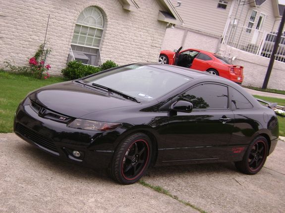 a black car parked in front of a house