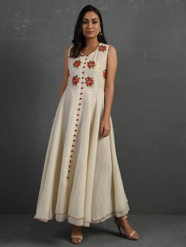 A double-layered umbrella cut front open Chanderi kurta with all-over floral buttis in yoke made using beads, sequins and silk French knots. Beadwork runs along the neckline and armhole. Contrast buttons and scalloped edges embroidered double layered flared hemline. The kurta comes with a delicate chanderi dupatta with all over sequence work and a wide woven zari border at the hem. Kurta measurements (in Inches): Size S: Bust - 38", Waist - 35", Length: 52" Size M: Bust - 40", Waist - 37", Lengt Traditional Cotton Silk Dresses With Floral Embroidery, Festive Cotton Silk Dress With Floral Embroidery, Designer Cotton Silk Dress With Floral Embroidery, Sleeveless Embroidered Kurta For Reception, Cotton Silk Dresses With Floral Embroidery For Designer Wear, Summer Embroidered Cotton Silk Dress, Spring Chanderi Anarkali Set With Mirror Work, Summer Chanderi Embroidered Dress With Floral Details, Summer Chanderi Embroidered Dress With Floral Embroidery