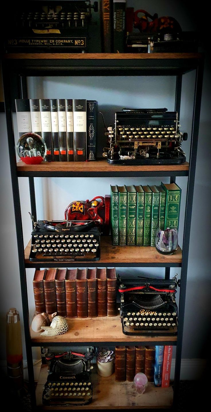 an old typewriter is sitting on a book shelf