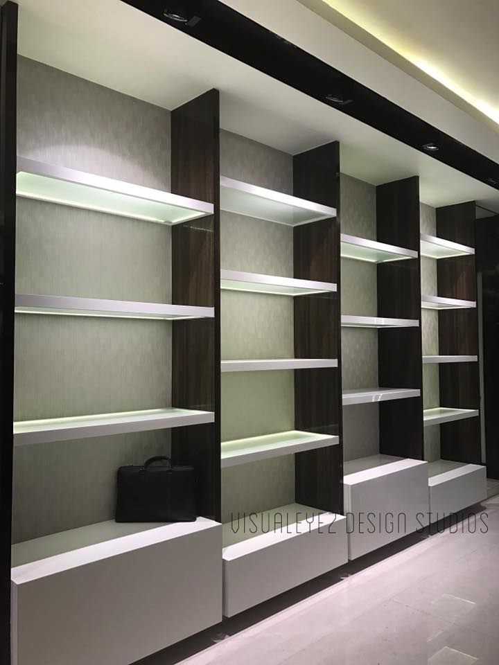 an empty walk in closet with several shelves