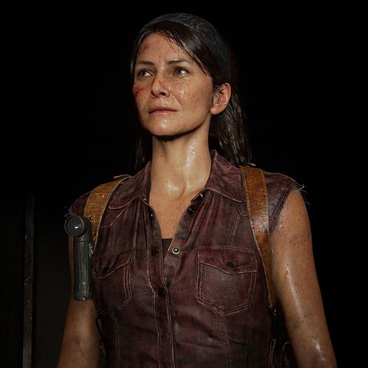 the walking dead's mica is looking at something in her hand while she stands next