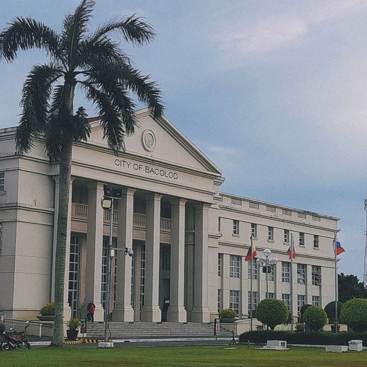 a large building with palm trees in front of it