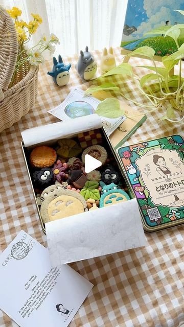 a box filled with lots of different types of cookies on top of a checkered table cloth