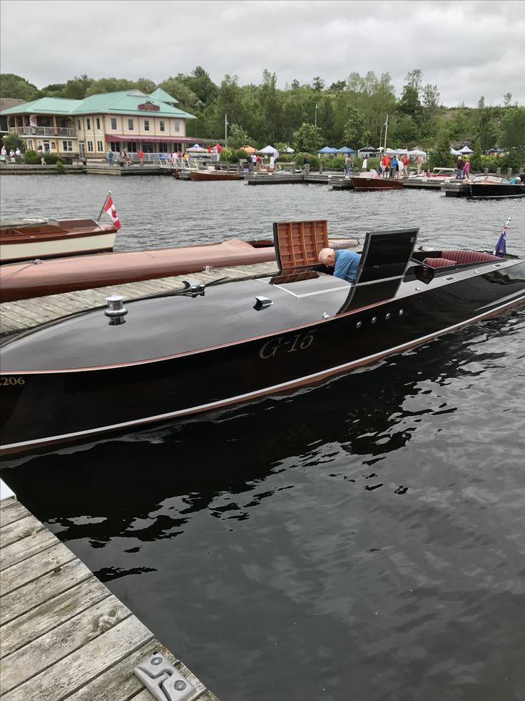 a black boat is docked at the dock