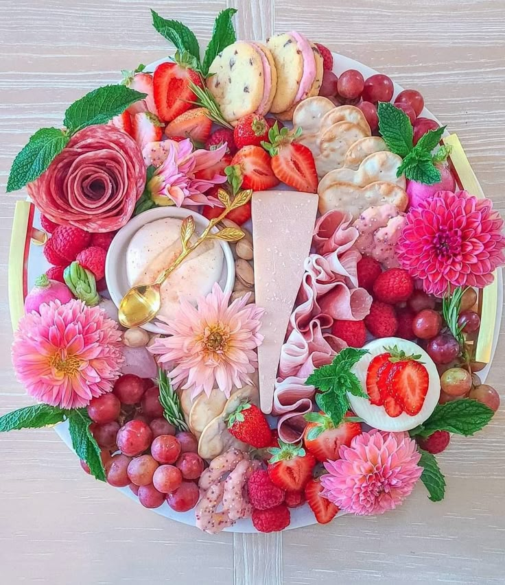 a plate filled with lots of different types of food and flowers on top of it