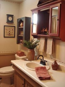 a bathroom with a sink, toilet and mirror