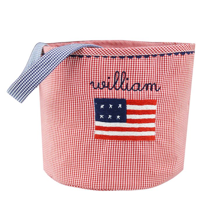 a red and white gingham basket with an american flag on the side, that says