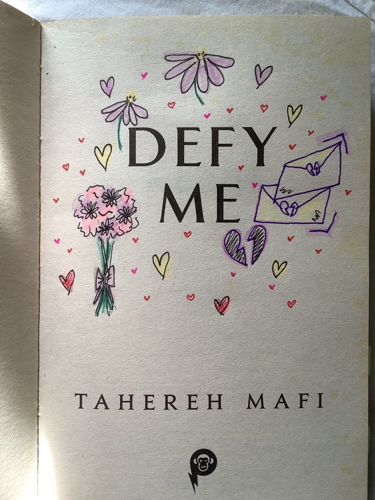 an open book with flowers and hearts drawn on the cover, which reads defy me