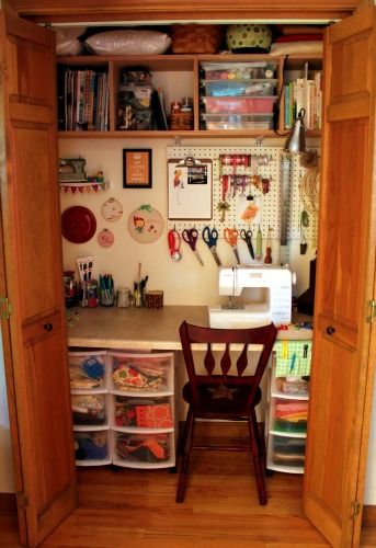 a sewing room with lots of crafting supplies in the cupboards and on the wall