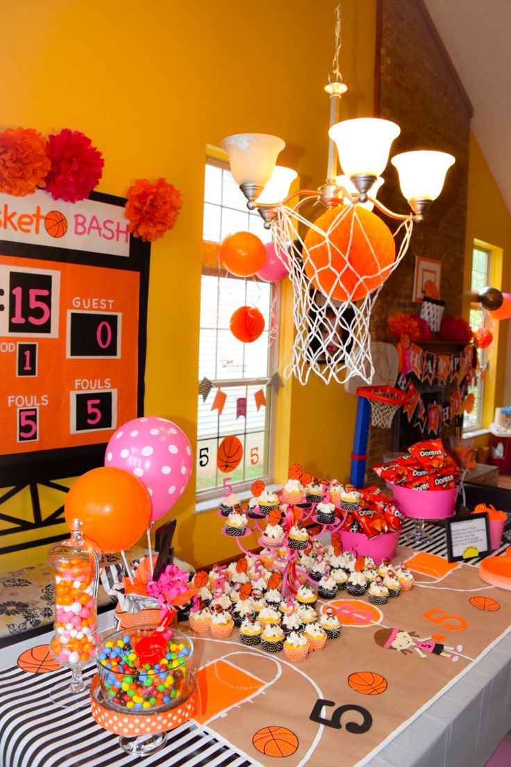 a basketball themed birthday party with cupcakes, candy, and snacks on the table