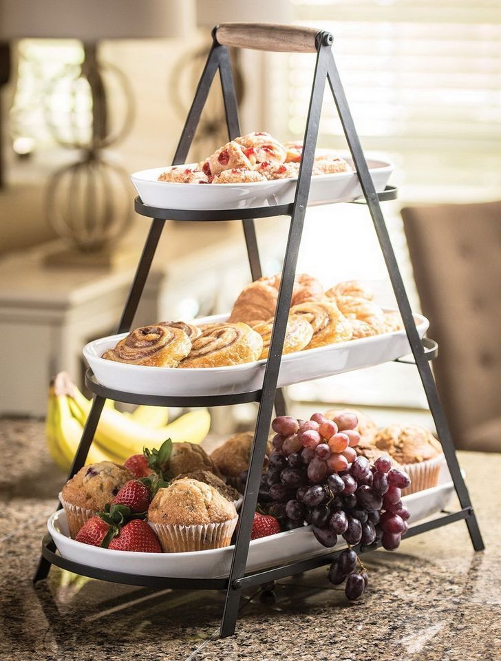 three tiered trays filled with different types of food