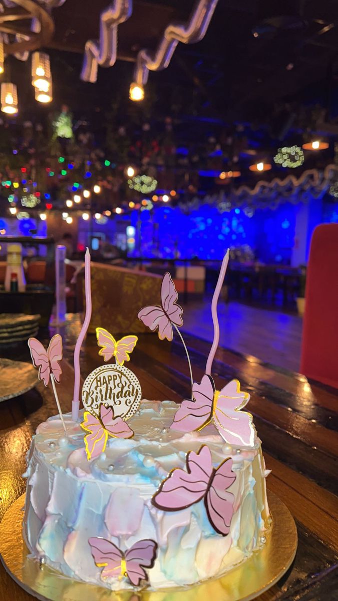 a decorated cake sitting on top of a wooden table