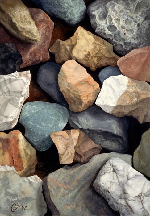 many rocks are stacked together on top of each other in different colors and shapes,