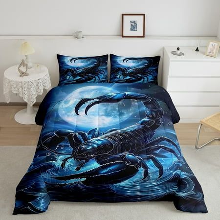 an image of a bed with blue comforter and pillows in the shape of a scorpion