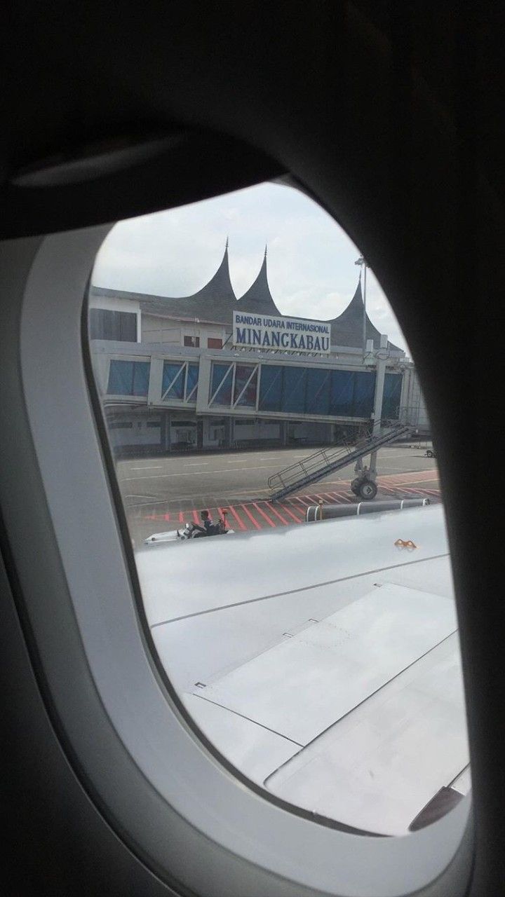 an airplane window looking out at the airport