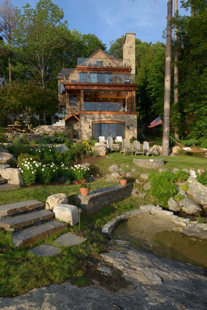 a house that is surrounded by trees and rocks