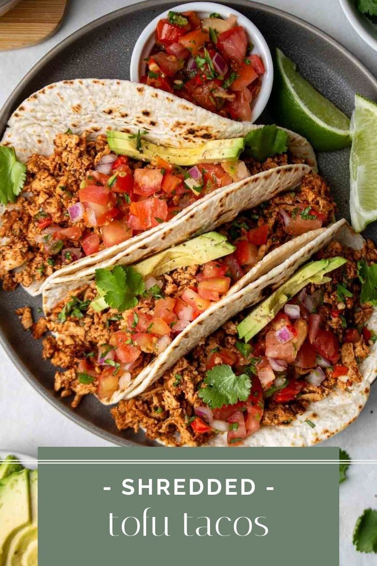 shredded tofu tacos on a plate with avocado and salsa