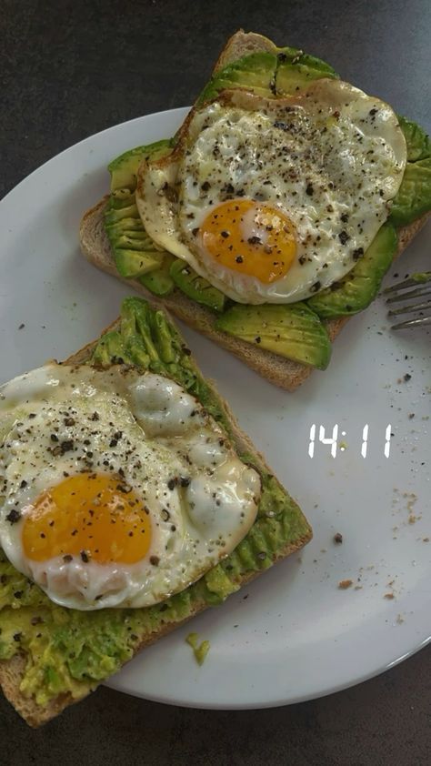 two pieces of toast with eggs on them