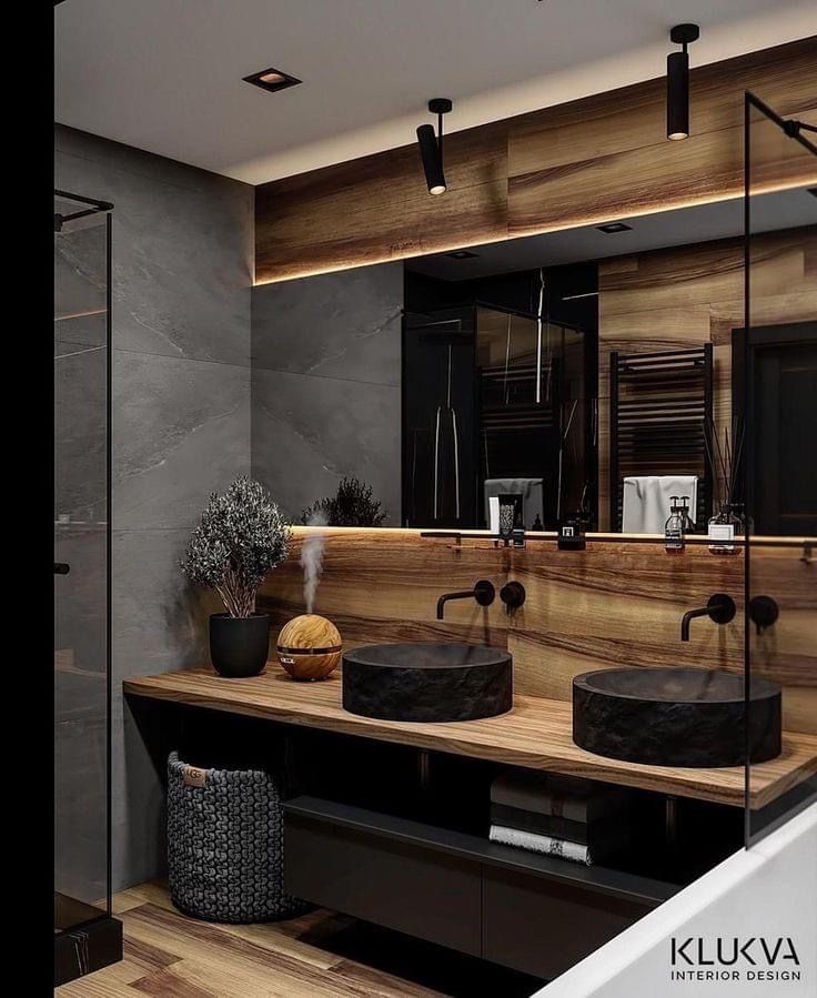 a bathroom with two sinks and a large mirror in the wall next to each other