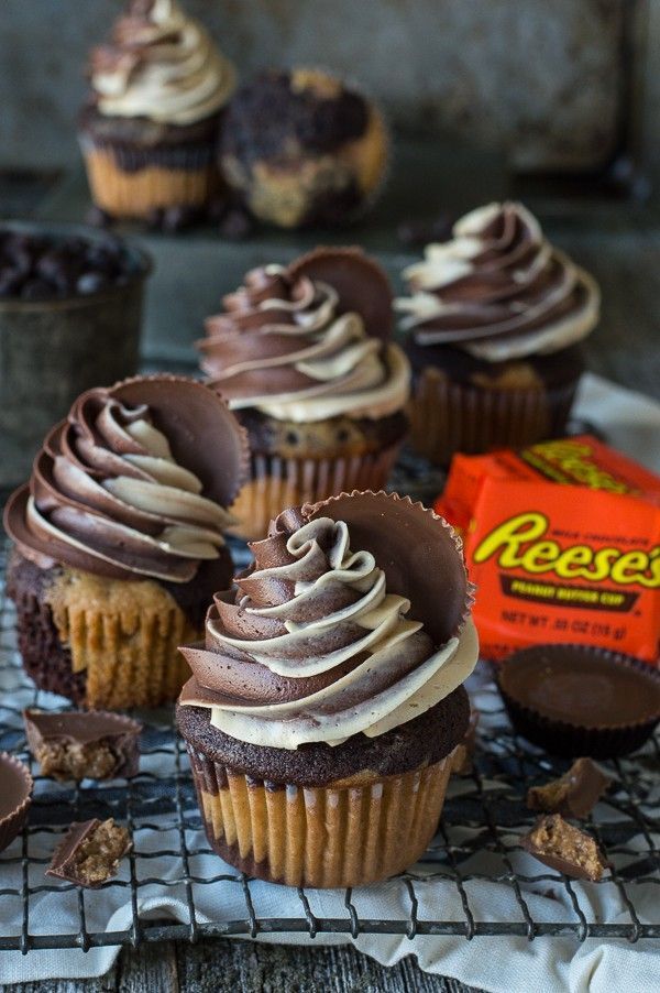 chocolate cupcakes on a cooling rack with reese's candy bar in the background