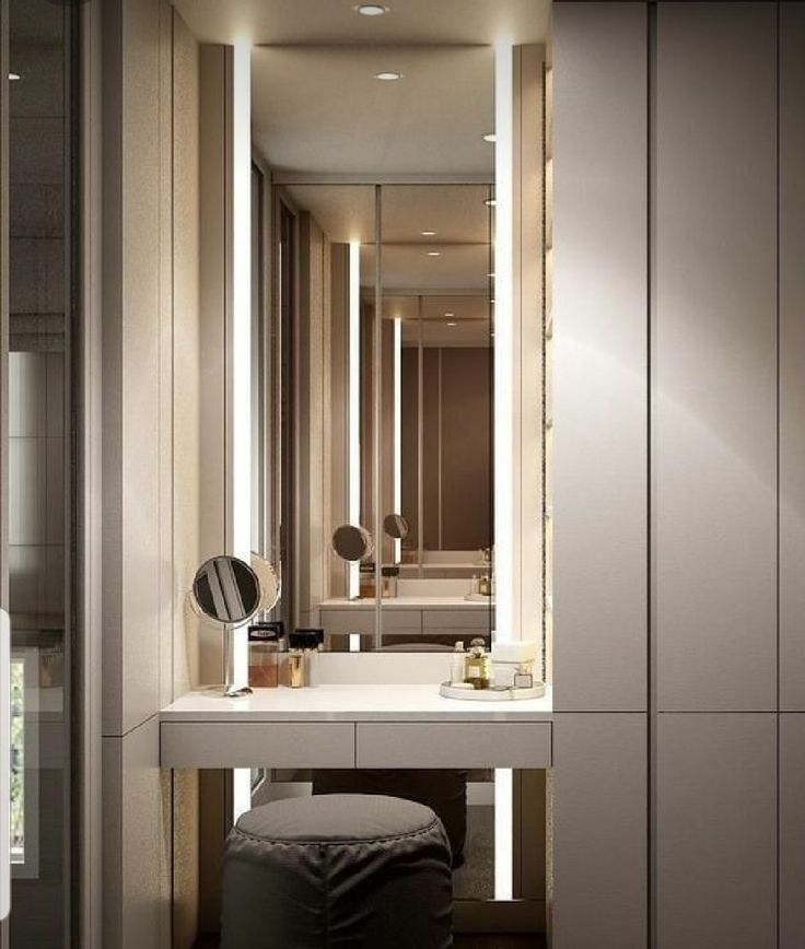 a bathroom with a vanity, mirror and stool next to the sink in front of it