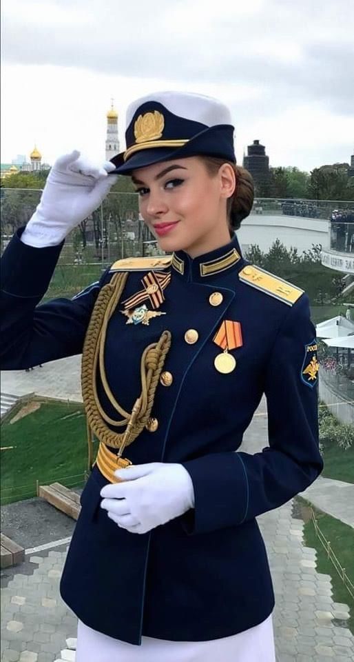 a woman in uniform saluting for the camera