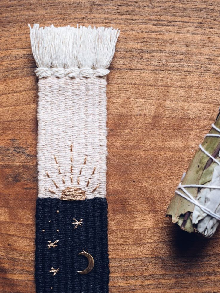 a white and black piece of cloth next to an object on a wooden table with string