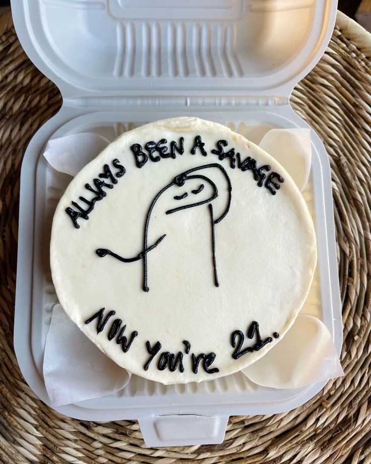 a cake in a plastic container that says always been a snake nin you're 29