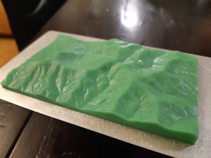 a piece of green cake sitting on top of a counter