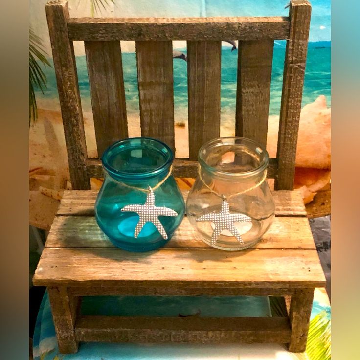 two glass jars sitting on top of a wooden bench next to a starfish bowl