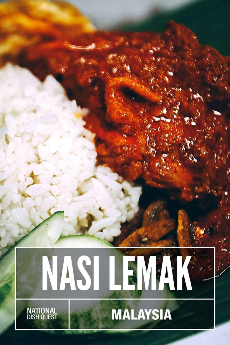 a plate with rice, meat and cucumber on it that says nasi lemak