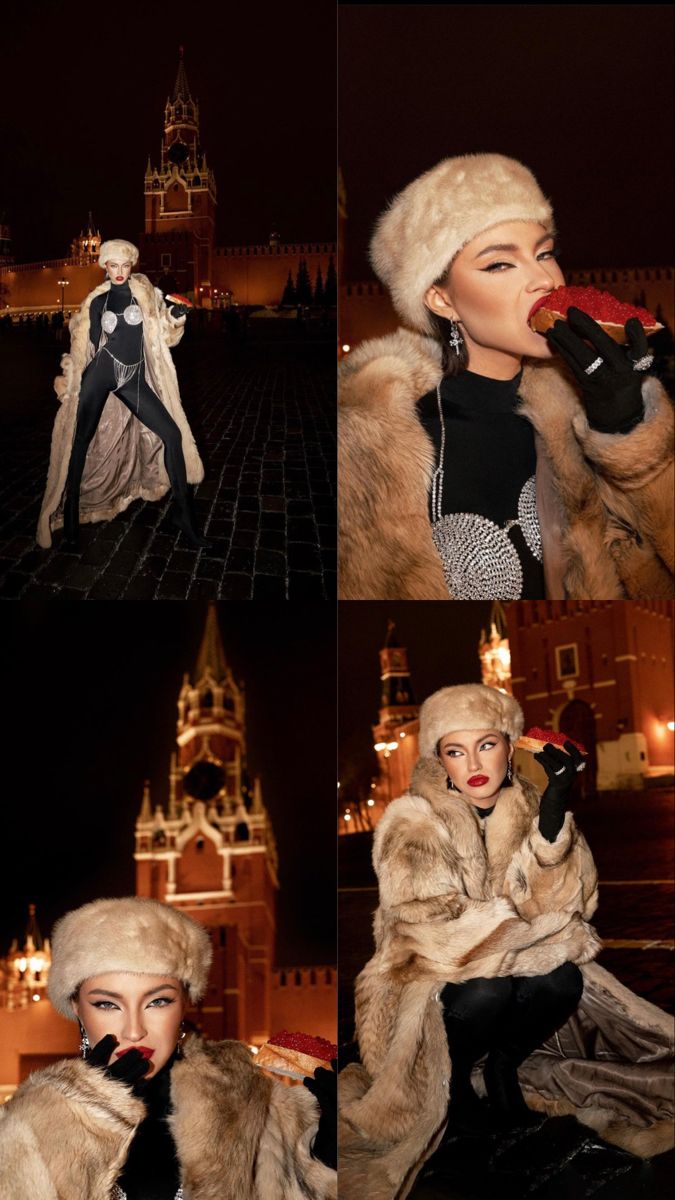 a woman in fur coat and hat drinking from a red cup at night with castle in the background