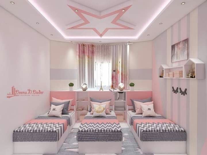 a pink and gray bedroom with two couches