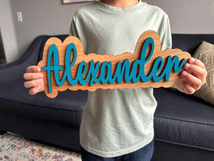 a young boy holding up a wooden sign that says hexundder