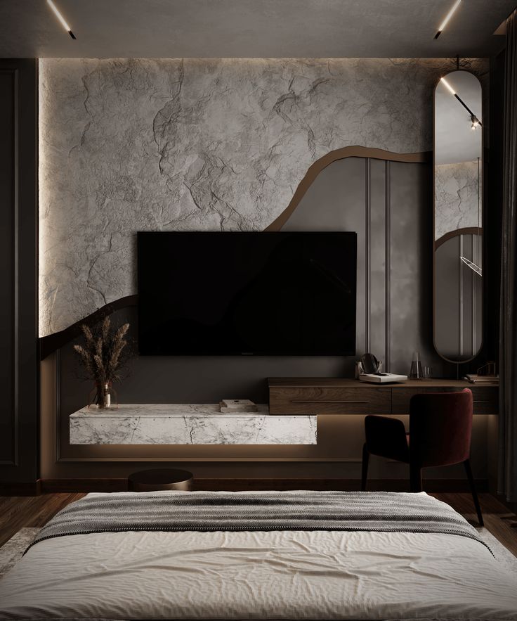 a bedroom with a large tv mounted on the wall next to a bed and mirror