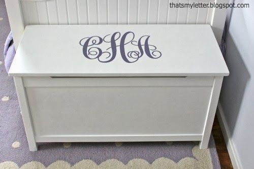 a white toy chest sitting on top of a rug