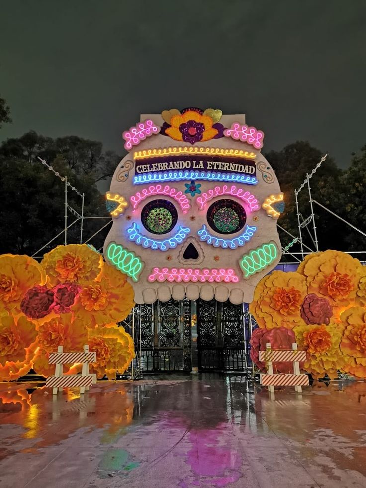 a large decorated sugar skull with flowers on it's head