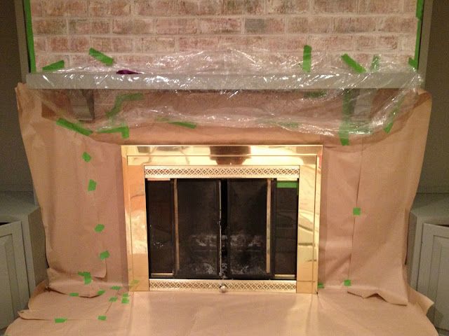 an unfinished fireplace in the middle of a room with plastic covering it's mantle