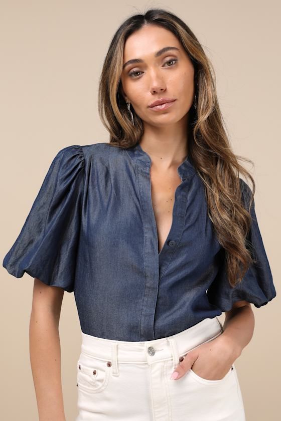 Bring a chic vibe to your everyday looks with the Lulus Contemporary Crush Dark Blue Chambray Puff Sleeve Button-Up Top! Lightweight woven chambray fabric shapes this stylish top that has pleated-like detailing at the shoulders and short puff sleeves with elastic at the cuffs. Crew neckline tops a functional, hidden button placket that runs down the bodice to rounded hems. Fit: This garment fits true to size. Length: Size medium measures 25" from shoulder to hem. Bust: Great for any cup size. Wa Denim Blue Button-up Workwear Blouse, Chic Denim Button-up Top, Chic Short Sleeve Denim Top For Day Out, Chic Short Sleeve Denim Blue Top, Trendy Denim Blouse For Day Out, Chic Denim Blue Short Sleeve Top, Fitted Denim Top With Puff Sleeves, Denim Blue Short Sleeve Blouse For Day Out, Fitted Denim Top For Summer Workwear