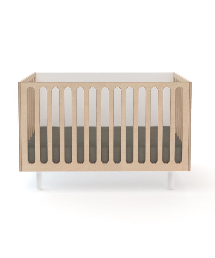 a wooden crib with grey and white stripes on the sides, in front of a white background