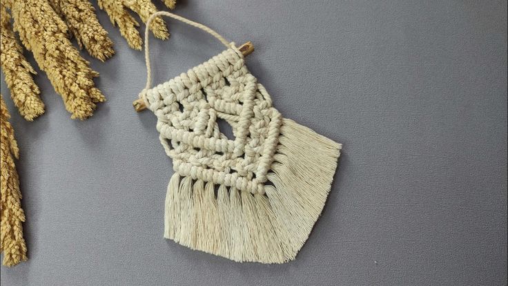 a piece of woven material hanging from a string